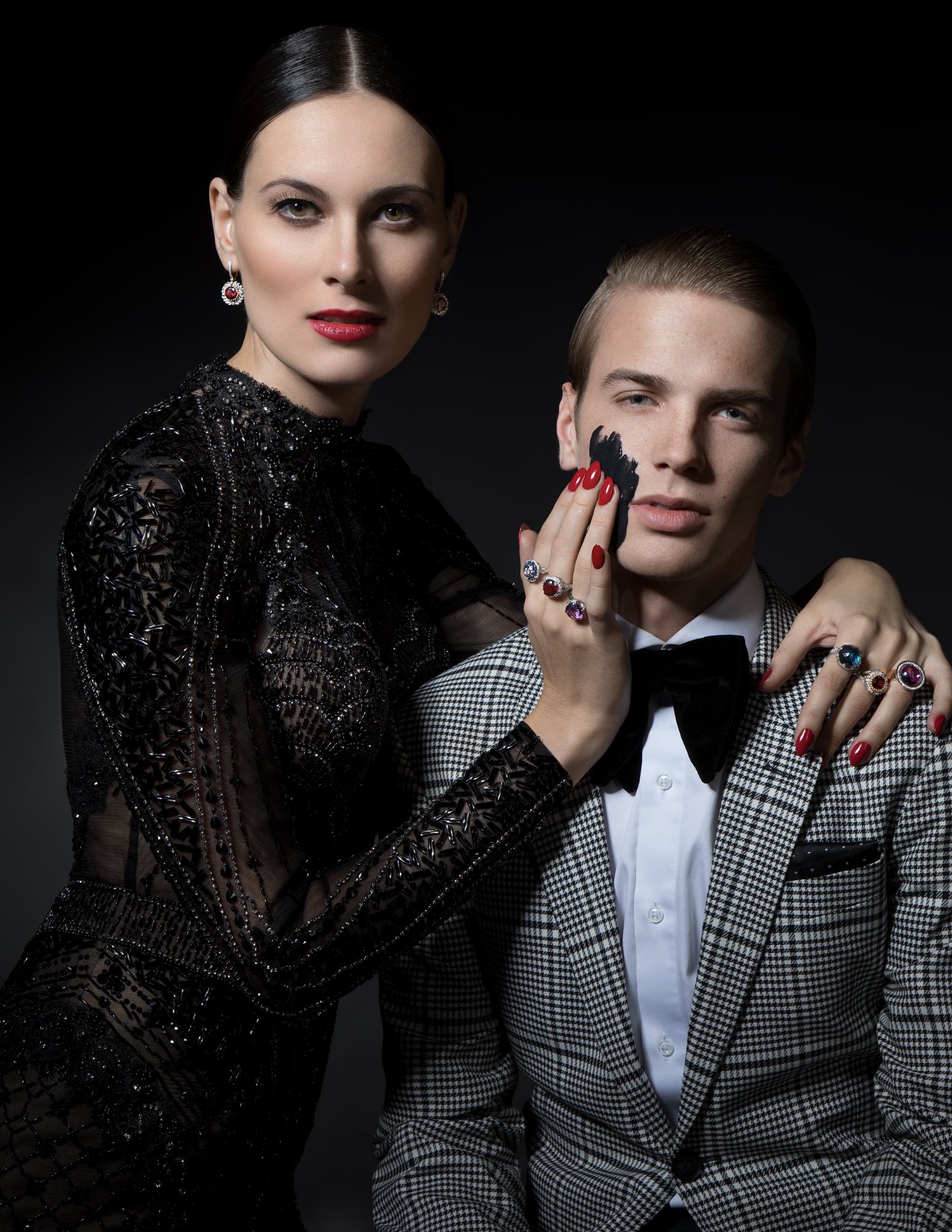 Gemstone cocktail rings with rubies, sapphires, and amethysts displayed on hands