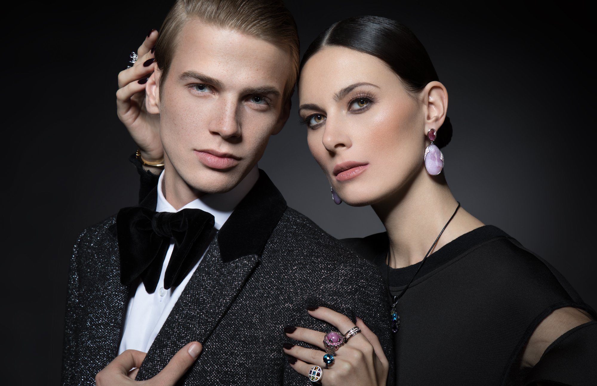Models wearing Yana's Design fine jewelry — gemstone rings, earrings, and pendant necklace in an elegant editorial setting